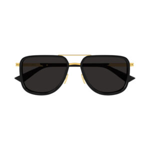 Black oversized sunglasses with gold metal bridge and temple accents and dark lenses.