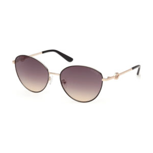 Gucci gold-tone sunglasses with gradient brown lenses and black tips on the temples, oval shape.