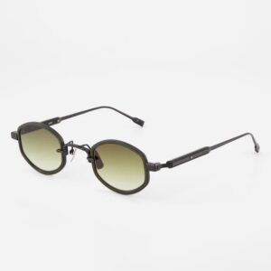 Round-oval sunglasses with dark frame and green-to-amber gradient lenses on a white background.