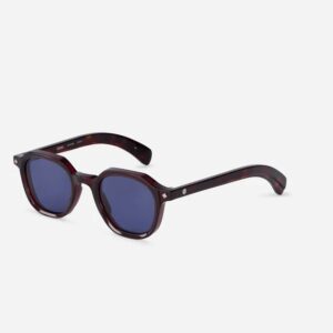 Dark tortoiseshell sunglasses with blue lenses shown from a front-side angle on a white background