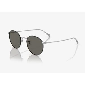 Round metal-framed sunglasses with dark lenses on a white reflective surface.