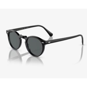 Black round-frame sunglasses with dark lenses on a white reflective surface.